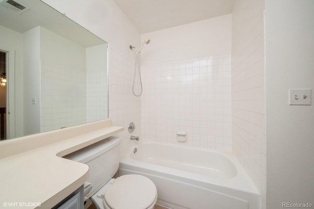 full bathroom featuring vanity, toilet, and tiled shower / bath