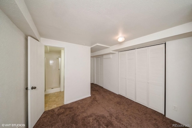 unfurnished bedroom with carpet floors and a textured ceiling