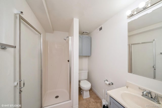 bathroom featuring vanity, toilet, and an enclosed shower