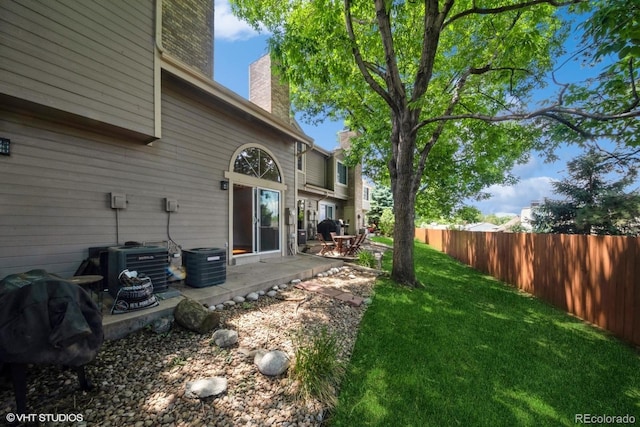 view of yard with a patio and central AC unit