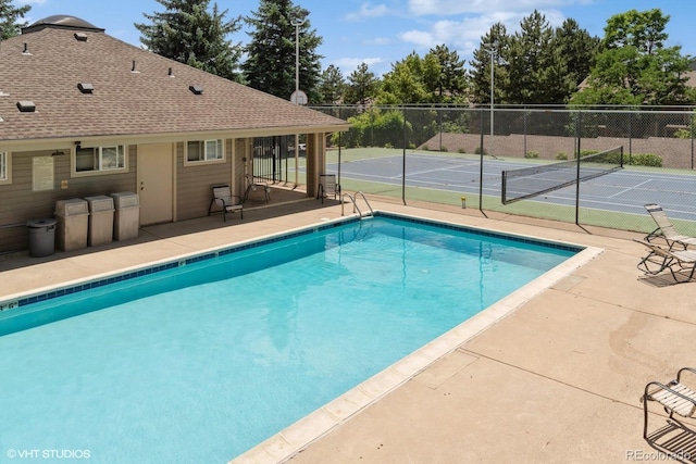 view of pool featuring tennis court