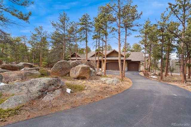 1524 Fox Acres Dr Unit 412, Red Feather Lakes, CO 80545 - view of front of home featuring driveway, an attached garage, and stone siding