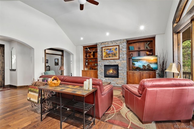 1524 Fox Acres Dr Unit 412, Red Feather Lakes, CO 80545 - living room with arched walkways, ceiling fan, a fireplace, built in shelves, and wood finished floors