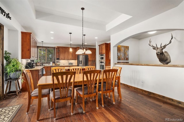 1524 Fox Acres Dr Unit 412, Red Feather Lakes, CO 80545 - dining room featuring a raised ceiling, dark wood-style floors, recessed lighting, and arched walkways