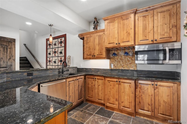 1524 Fox Acres Dr Unit 412, Red Feather Lakes, CO 80545 - kitchen with appliances with stainless steel finishes, a peninsula, tasteful backsplash, dark stone finish floors, and recessed lighting