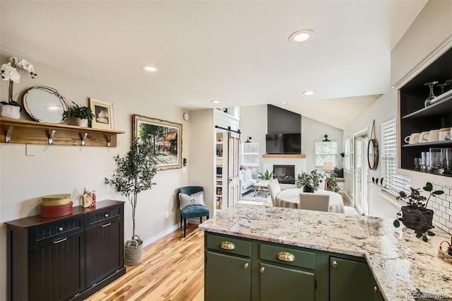 16626 Ouray Rd W, Pine, CO 80470 - kitchen featuring green cabinets, a peninsula, open shelves, light wood-style floors, and recessed lighting