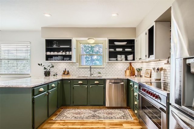 16626 Ouray Rd W, Pine, CO 80470 - kitchen featuring green cabinetry, a sink, appliances with stainless steel finishes, decorative backsplash, and recessed lighting
