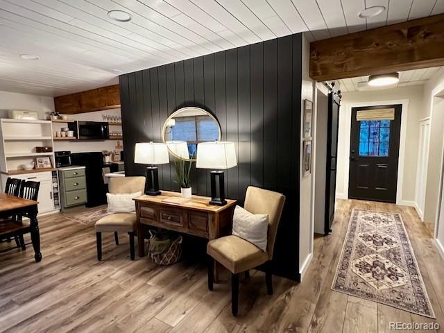 16626 Ouray Rd W, Pine, CO 80470 - sitting room with light wood-style floors, wood walls, and wood ceiling