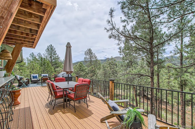 16626 Ouray Rd W, Pine, CO 80470 - wooden deck with outdoor dining area and outdoor lounge area