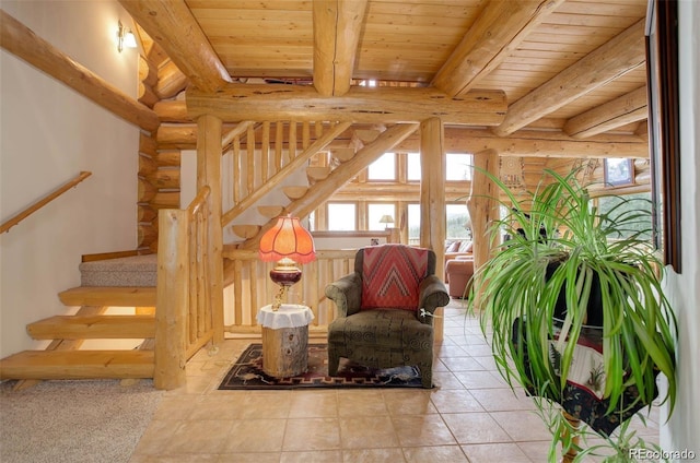 interior space featuring rustic walls, beamed ceiling, and wood ceiling