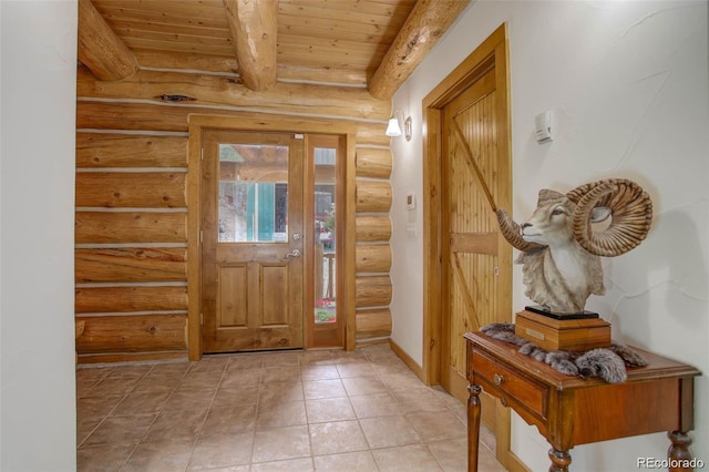 foyer entrance with beam ceiling, wooden ceiling, and rustic walls