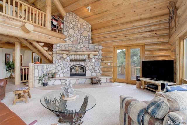 carpeted living room featuring rustic walls, french doors, high vaulted ceiling, and a stone fireplace