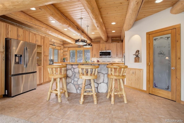 kitchen featuring rustic walls, wooden ceiling, beamed ceiling, and stainless steel appliances