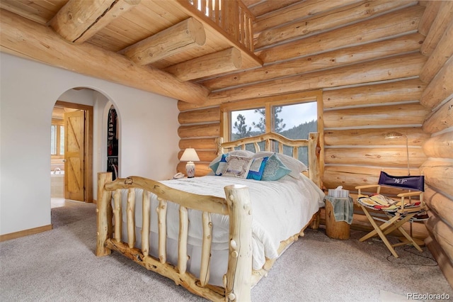 bedroom with beamed ceiling, light colored carpet, wood ceiling, and log walls