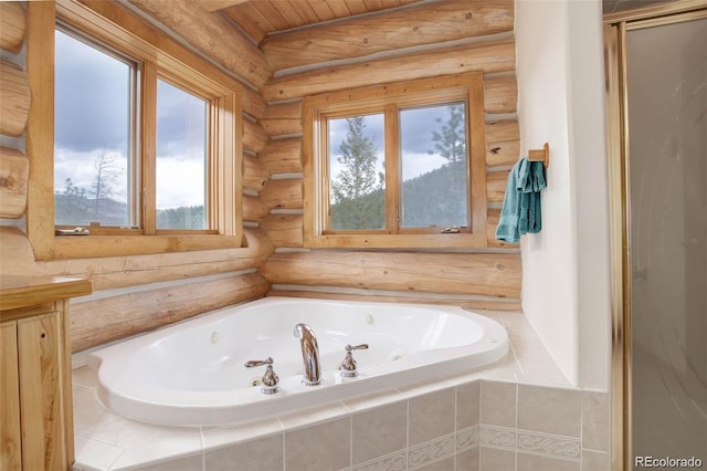 bathroom with wood ceiling, tiled tub, log walls, and a healthy amount of sunlight