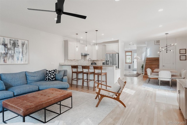 2034 Newton St, Denver, CO 80211 - living room featuring a chandelier, recessed lighting, light wood finished floors, and a ceiling fan