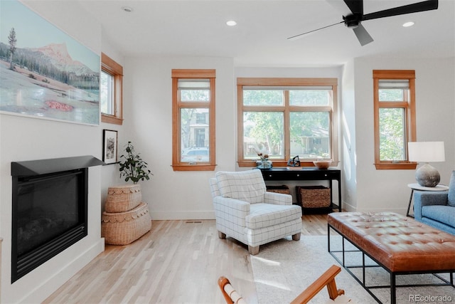 2034 Newton St, Denver, CO 80211 - living room with wood finished floors, a glass covered fireplace, ceiling fan, baseboards, and recessed lighting