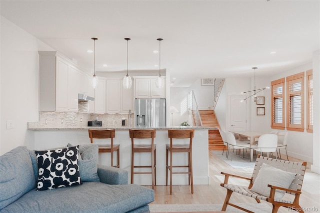 2034 Newton St, Denver, CO 80211 - living room with stairway, light wood finished floors, recessed lighting, and baseboards
