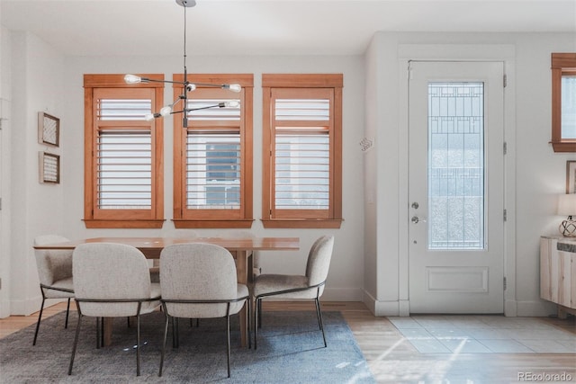 2034 Newton St, Denver, CO 80211 - dining room with radiator heating unit, healthy amount of natural light, baseboards, and wood finished floors