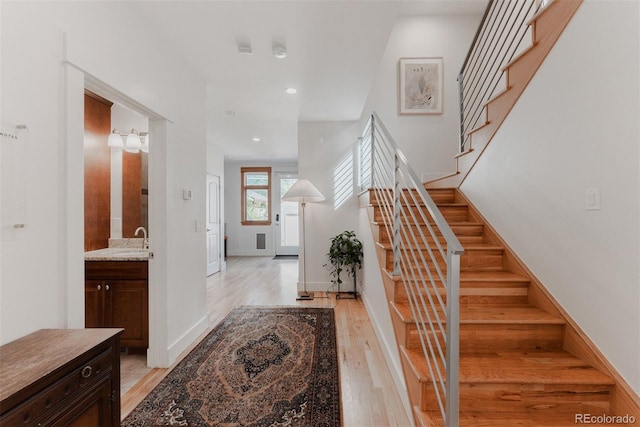 2034 Newton St, Denver, CO 80211 - foyer entrance featuring light wood finished floors, stairs, recessed lighting, and baseboards