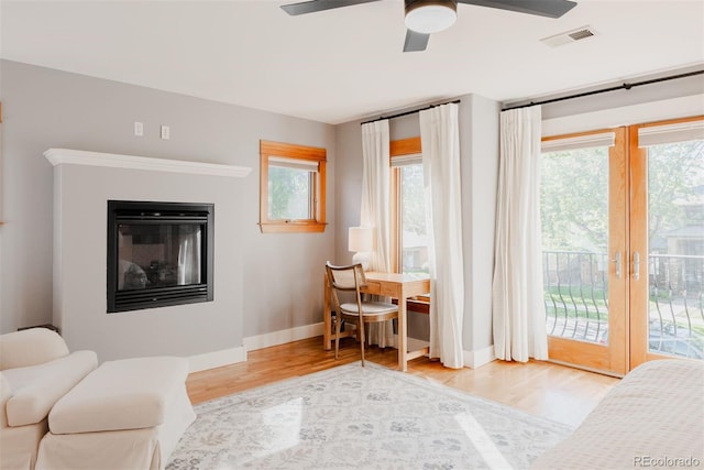 2034 Newton St, Denver, CO 80211 - living room featuring wood finished floors, baseboards, a ceiling fan, and a glass covered fireplace