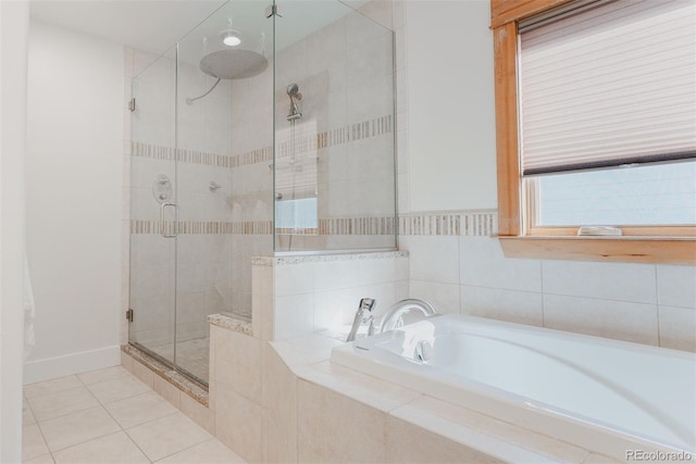 2034 Newton St, Denver, CO 80211 - bathroom featuring a stall shower, a bath, tile patterned flooring, and baseboards