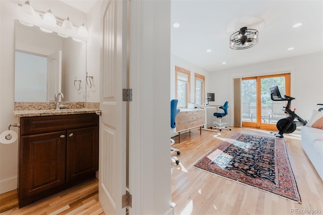 2034 Newton St, Denver, CO 80211 - bathroom featuring wood finished floors, vanity, a bathtub, and recessed lighting