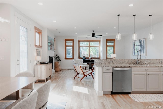 2034 Newton St, Denver, CO 80211 - kitchen featuring stainless steel dishwasher, light wood-style flooring, open floor plan, and recessed lighting