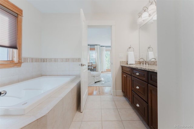 2034 Newton St, Denver, CO 80211 - ensuite bathroom featuring vanity, a garden tub, and tile patterned floors