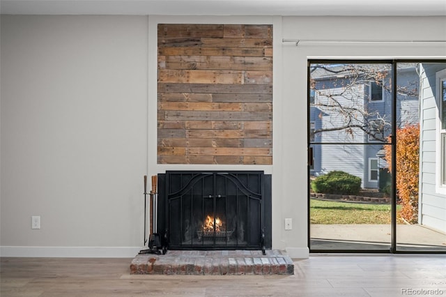 details with wood-type flooring and a brick fireplace