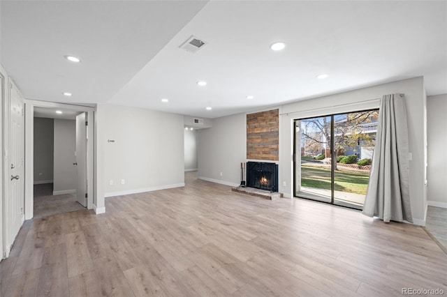 unfurnished living room featuring light hardwood / wood-style floors and a fireplace