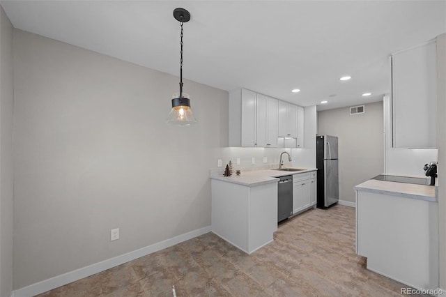 kitchen featuring decorative light fixtures, white cabinetry, sink, and stainless steel appliances