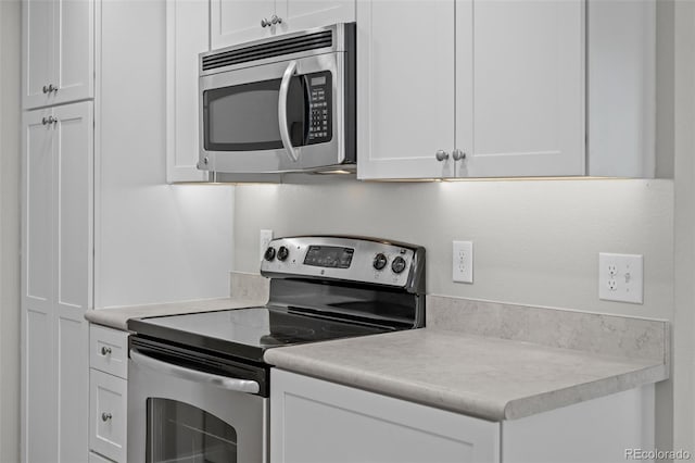 kitchen with appliances with stainless steel finishes and white cabinetry