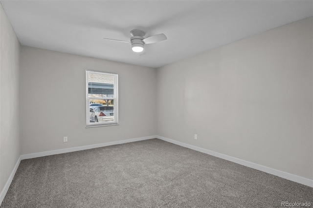 carpeted empty room featuring ceiling fan