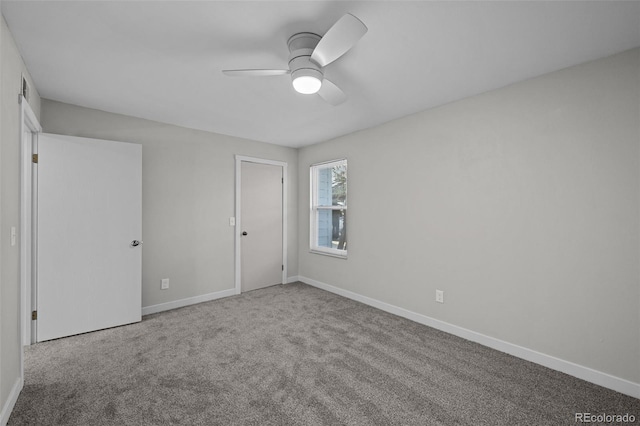 carpeted spare room featuring ceiling fan