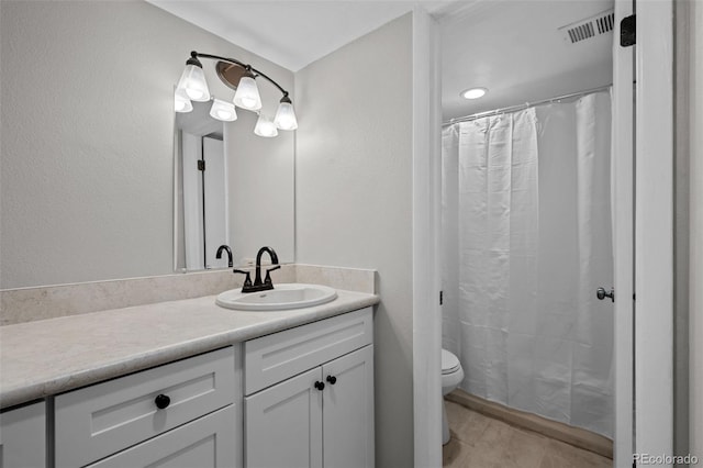 bathroom featuring tile patterned floors, curtained shower, vanity, and toilet