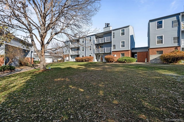 back of house featuring a yard