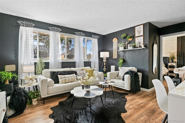 living room featuring a wealth of natural light, light hardwood / wood-style flooring, and a textured ceiling