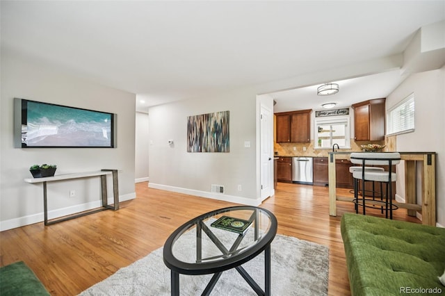2880 S High St, Denver, CO 80210 - living room featuring light wood finished floors and baseboards