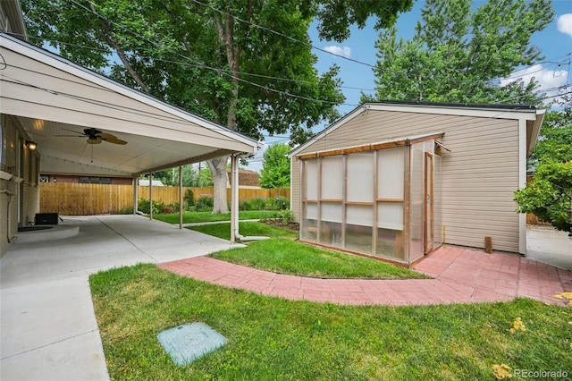 2880 S High St, Denver, CO 80210 - fenced backyard featuring ceiling fan, an outdoor structure, an exterior structure, and a patio
