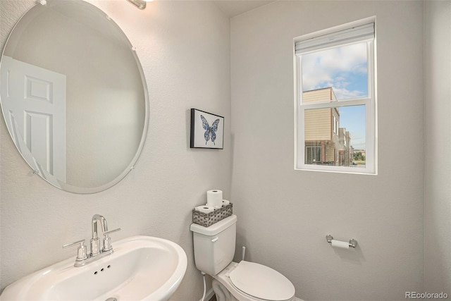 bathroom with toilet and a sink