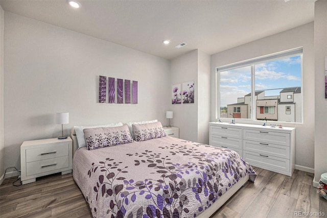 bedroom with recessed lighting, baseboards, and light wood-style floors