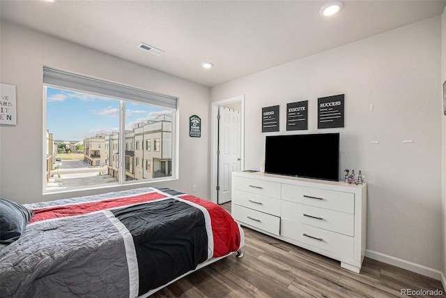 bedroom featuring recessed lighting, wood finished floors, visible vents, and baseboards