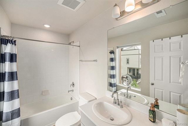 bathroom featuring visible vents, vanity, toilet, and shower / tub combo