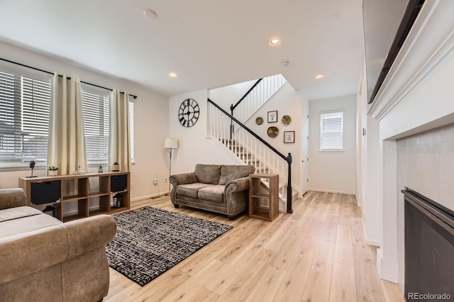 1420 E Witherspoon Dr, Elizabeth, CO 80107 - living area featuring stairs, light wood-style flooring, baseboards, recessed lighting, and a fireplace