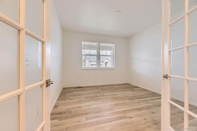 1420 E Witherspoon Dr, Elizabeth, CO 80107 - empty room featuring french doors, wood finished floors, and baseboards