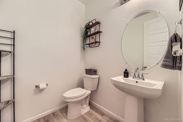 1420 E Witherspoon Dr, Elizabeth, CO 80107 - bathroom featuring toilet, wood finished floors, and baseboards