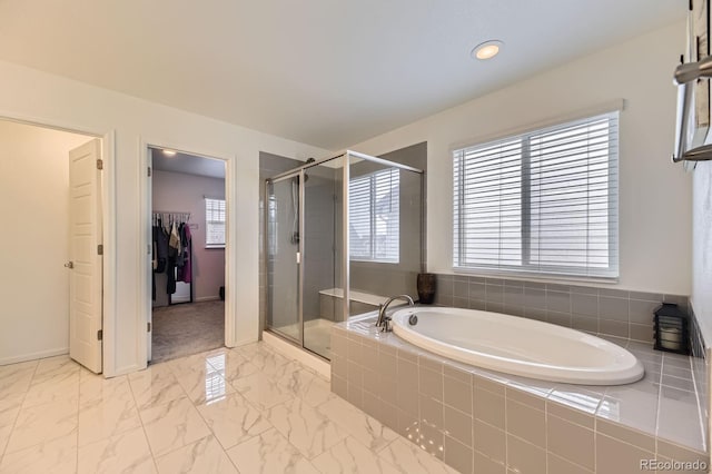 1420 E Witherspoon Dr, Elizabeth, CO 80107 - full bathroom with a garden tub, a shower stall, a walk in closet, marble look tile flooring, and baseboards