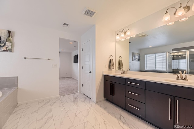 1420 E Witherspoon Dr, Elizabeth, CO 80107 - bathroom with double vanity, baseboards, a garden tub, marble look tile flooring, and a shower with door