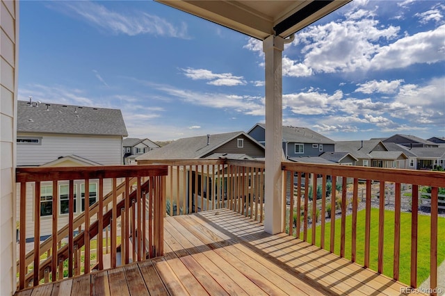 wooden deck featuring a lawn